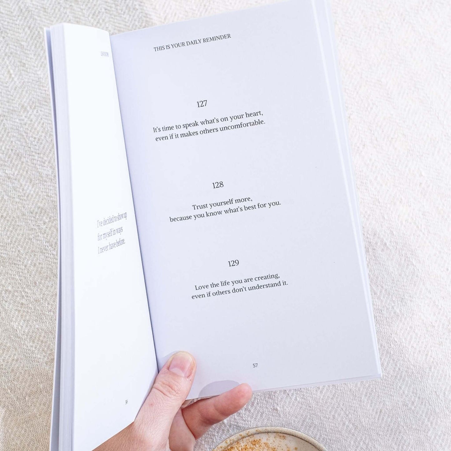 Open page of the Gentle Daily Reminders Book by Lisa Buscomb showing inspirational quotes for self-love and mindfulness.