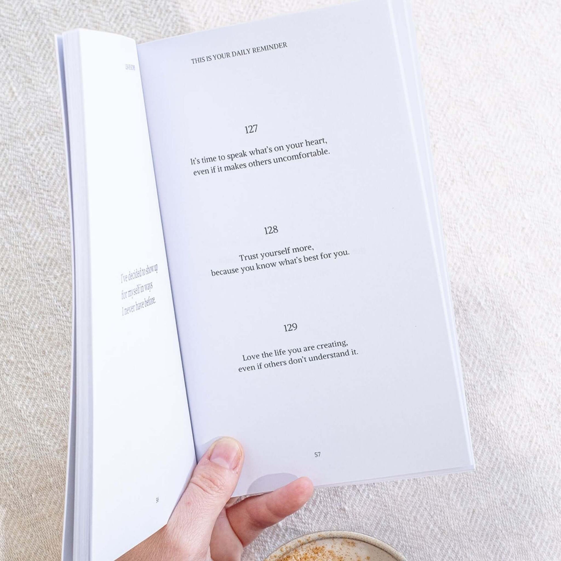 Open page of the Gentle Daily Reminders Book by Lisa Buscomb showing inspirational quotes for self-love and mindfulness.